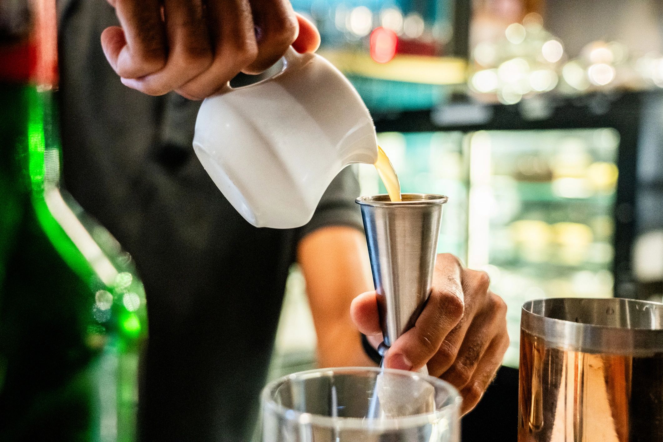 Close-up of bartender preparing a cocktail on a bar top