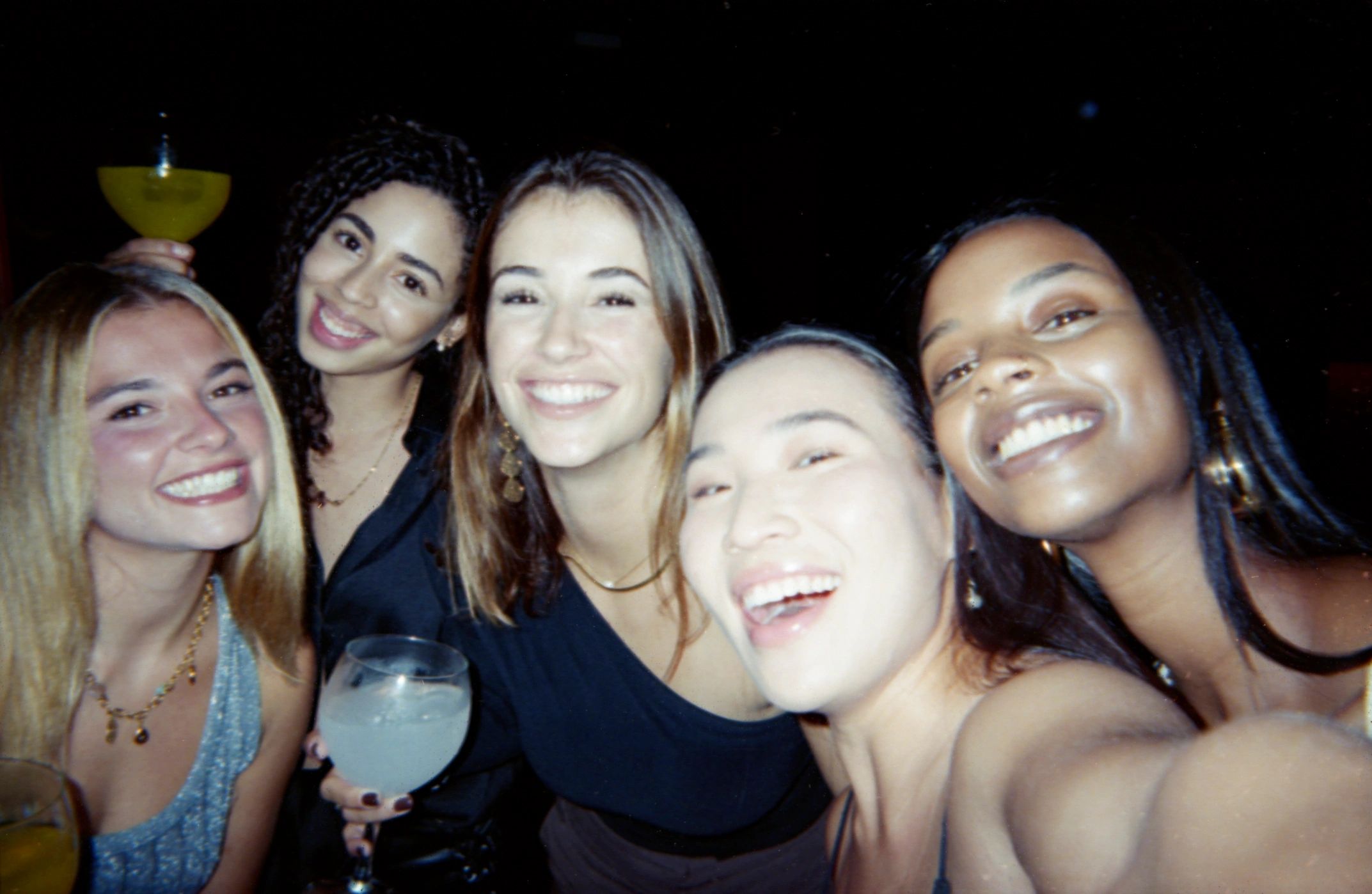 Group of friends celebrating with drinks at an event