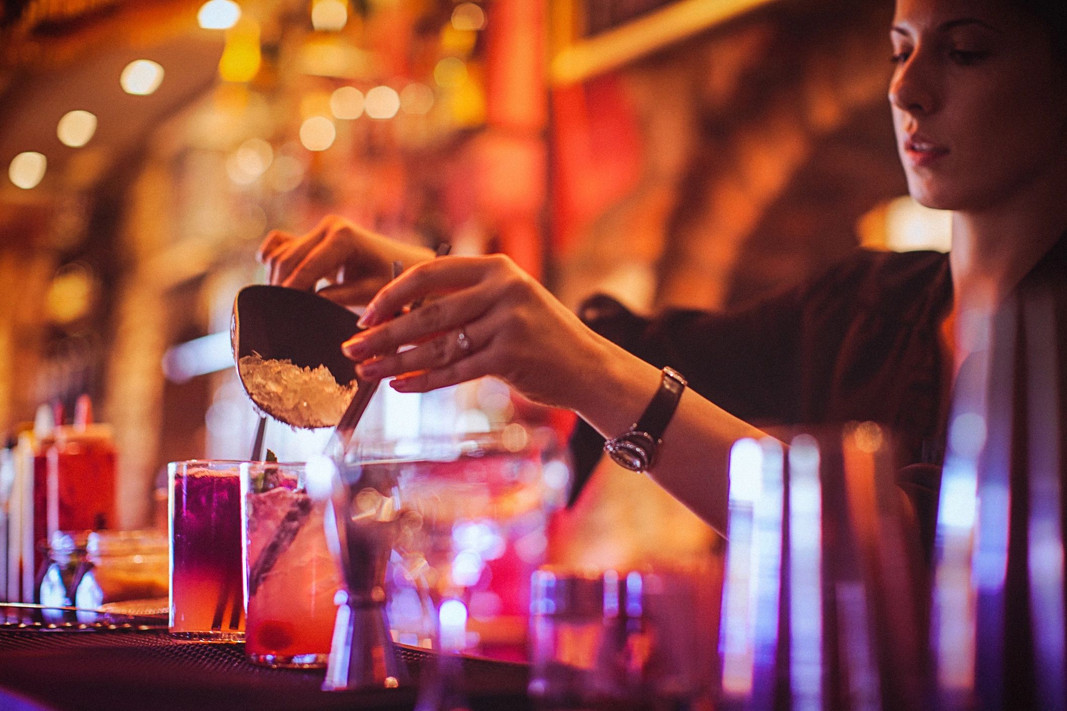 Bartender preparing cocktails at a bar station
