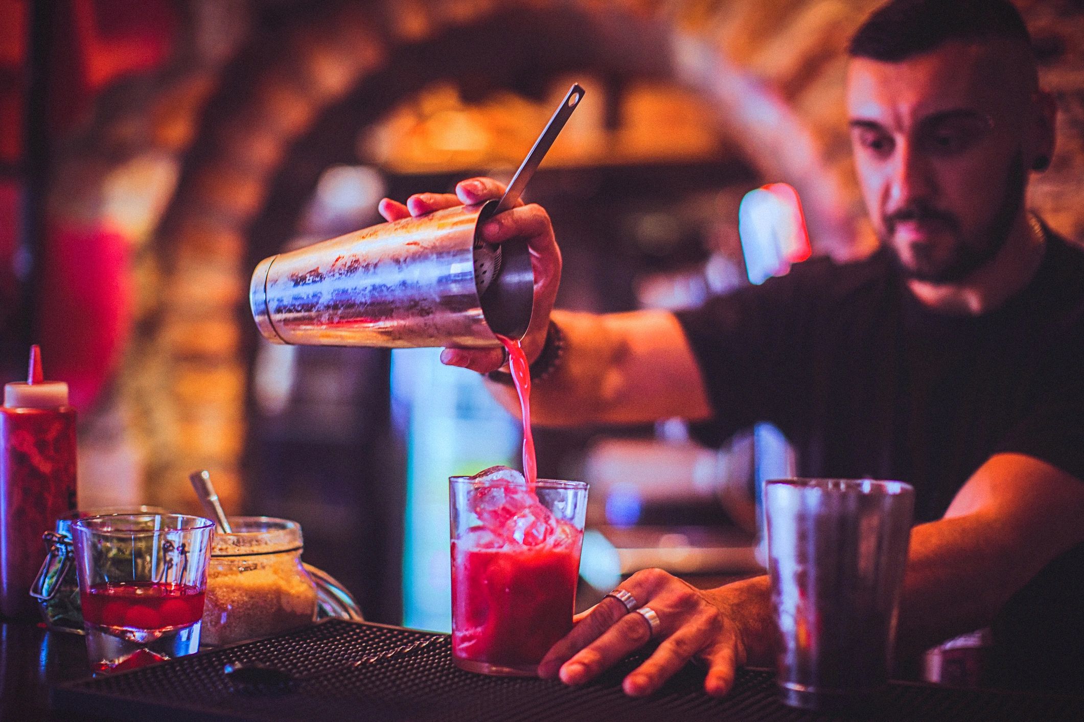 Bartender pouring a cocktail at an event